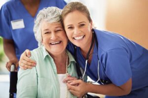 An older adult smiles while unpacking personal belongings in a bright, neatly arranged room.